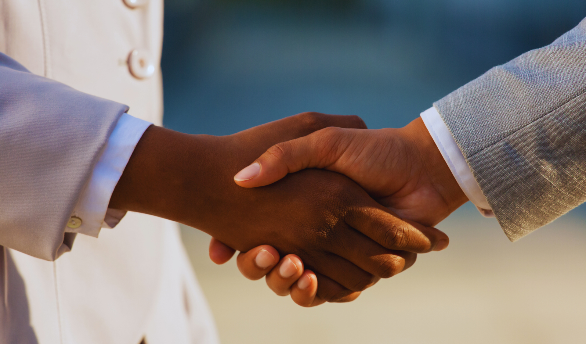 Healthcare and business professionals joining hands